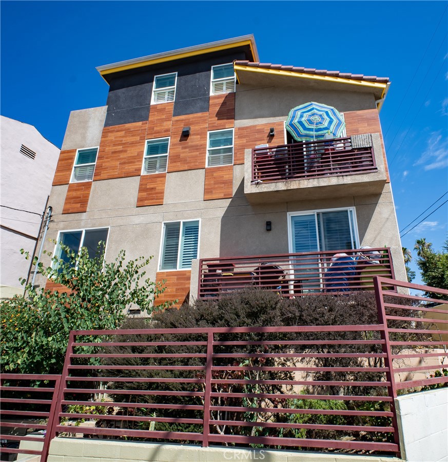 a front view of a multi story building with yard