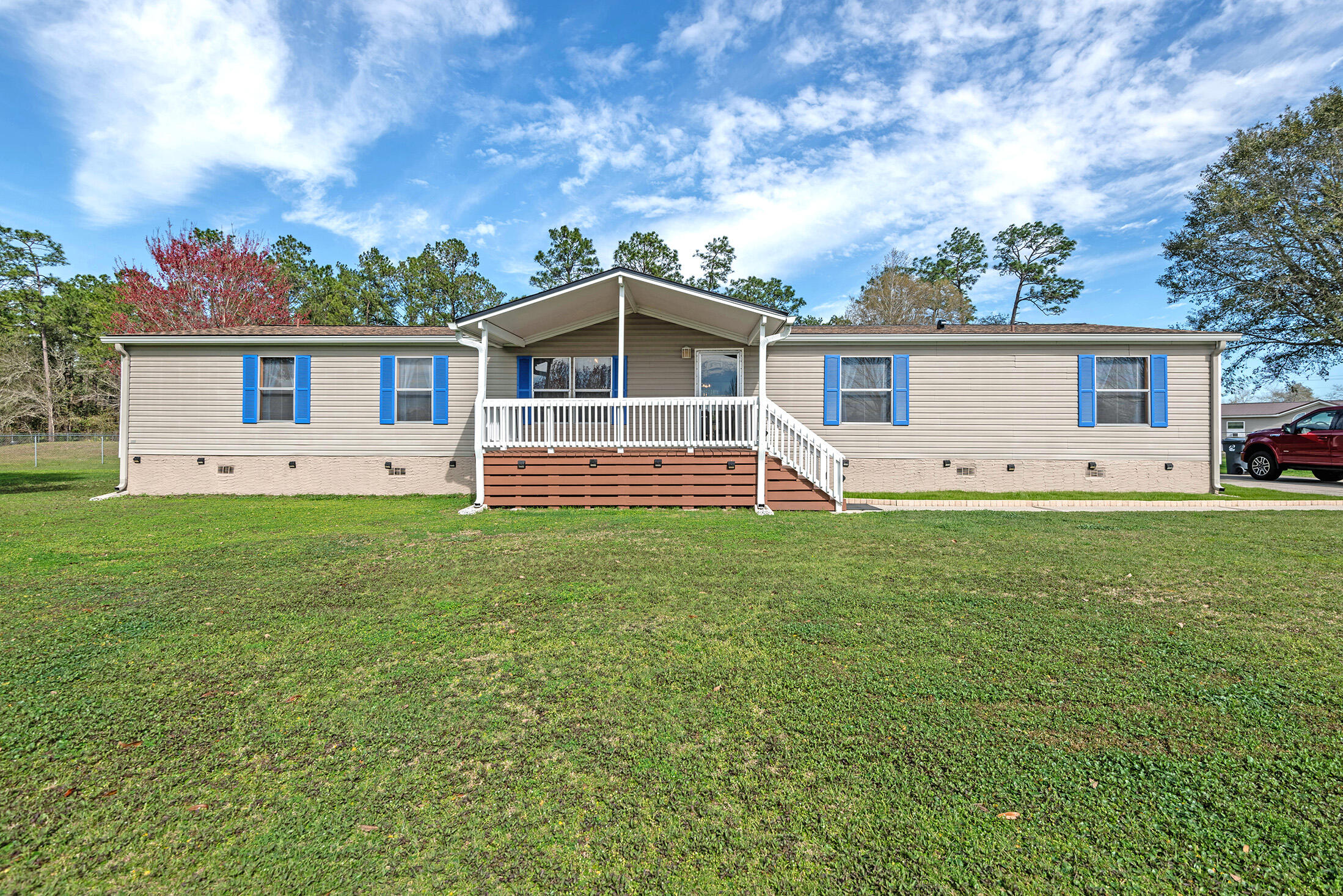 a front view of house with yard and green space