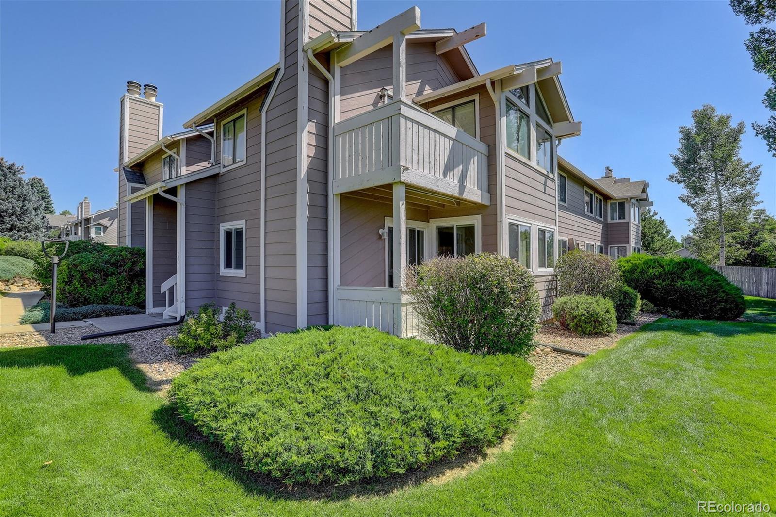 a view of a house with a backyard and plants