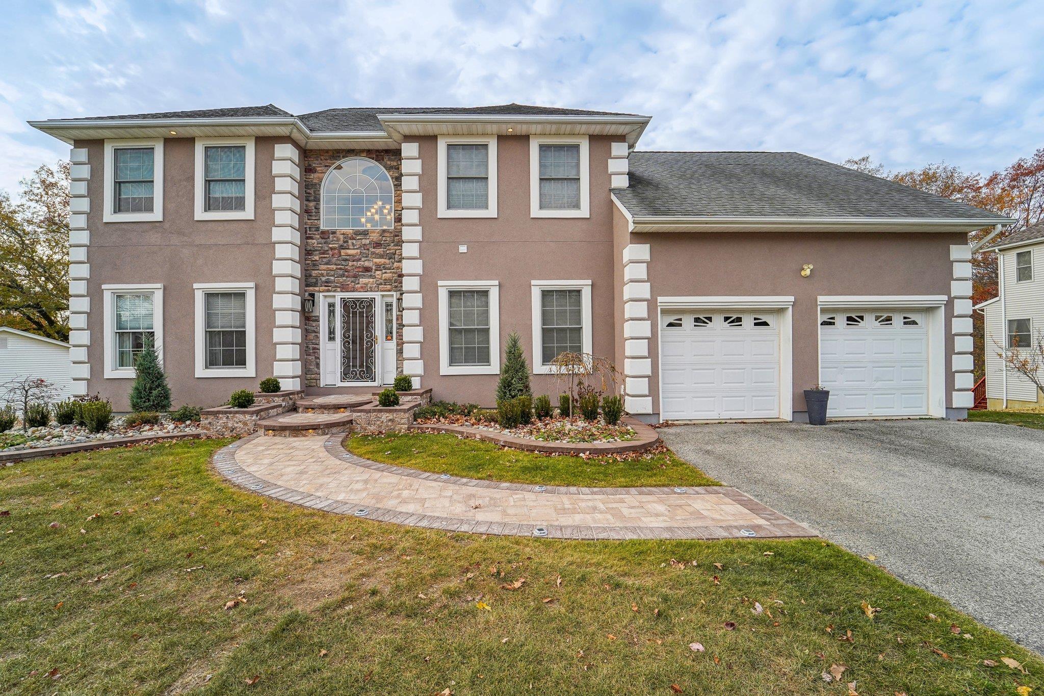 View of front facade with a front yard and a garage