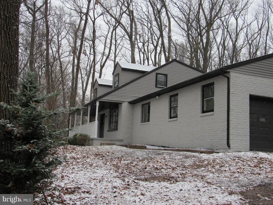 a house that has a tree in front of it