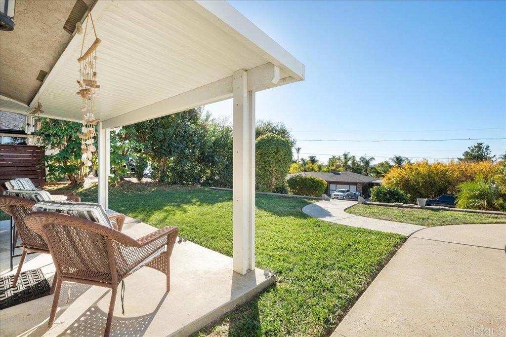 a view of a patio with table and chairs potted plants with wooden floor