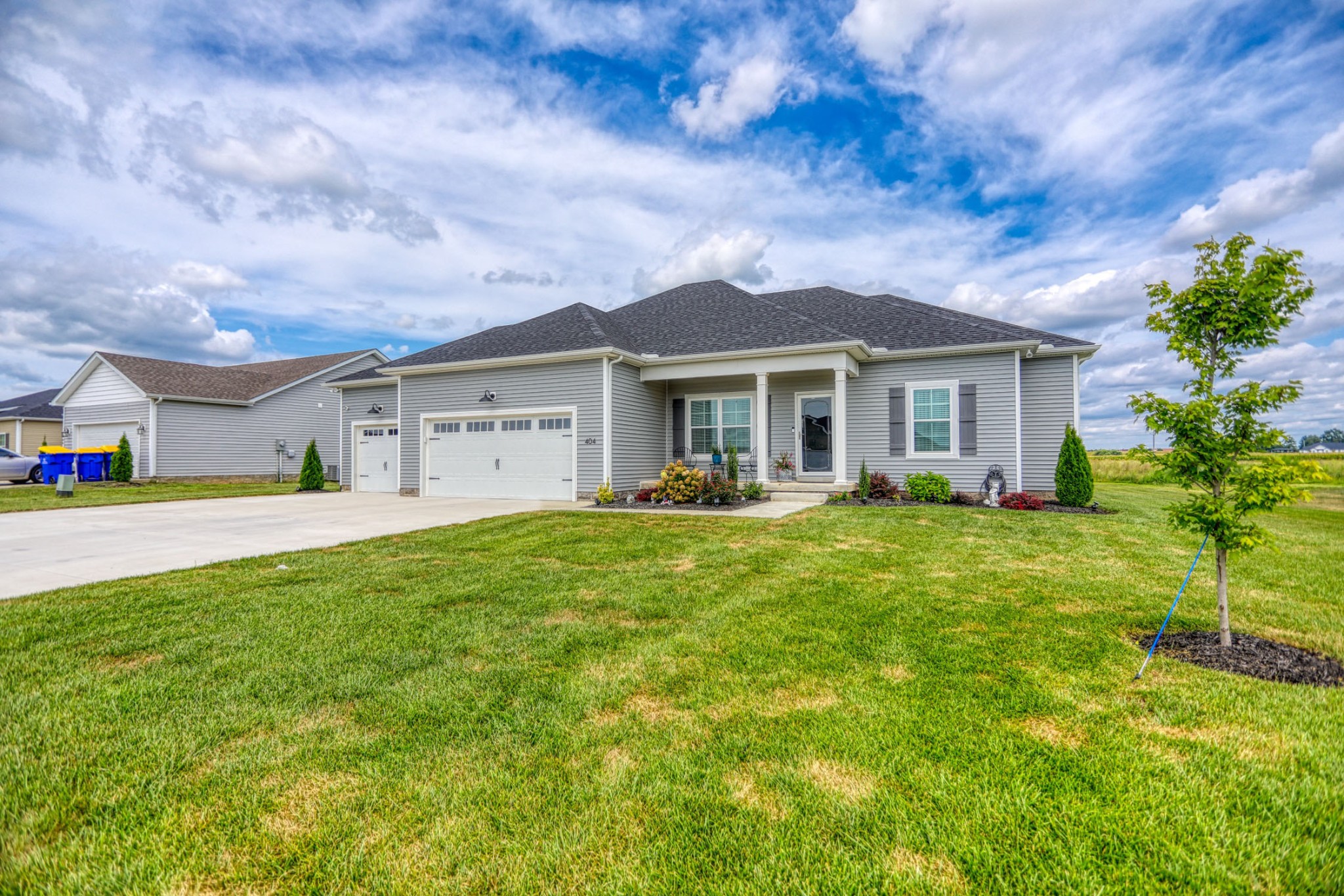 a front view of house with yard and green space