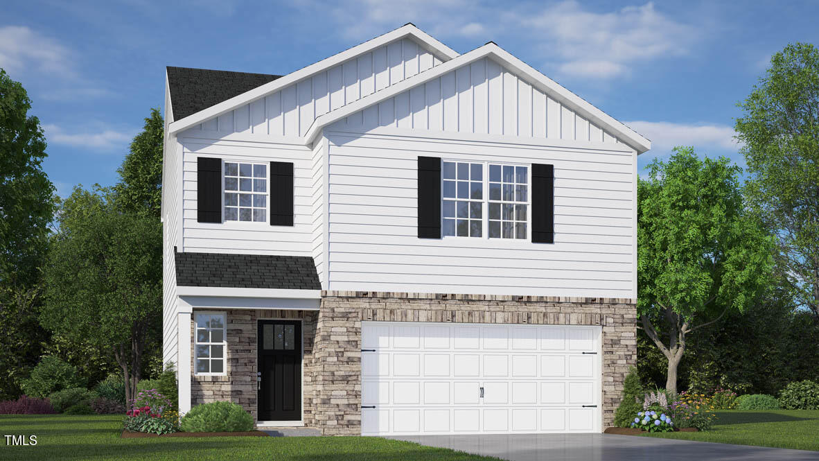 a view of a house with garage and yard