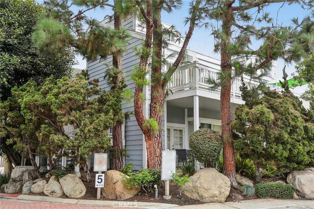 a front view of a house with plants