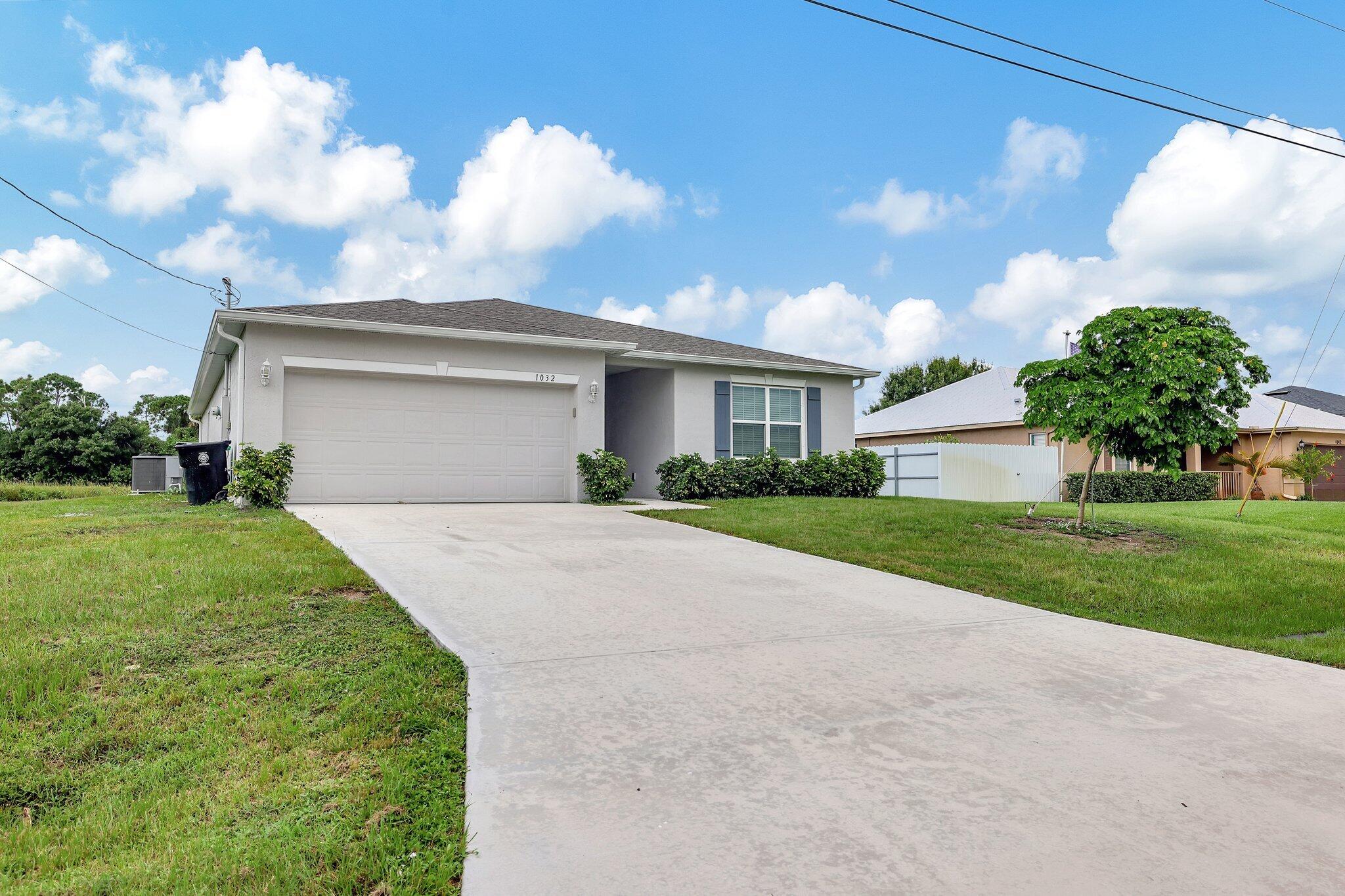 a front view of house with yard and green space