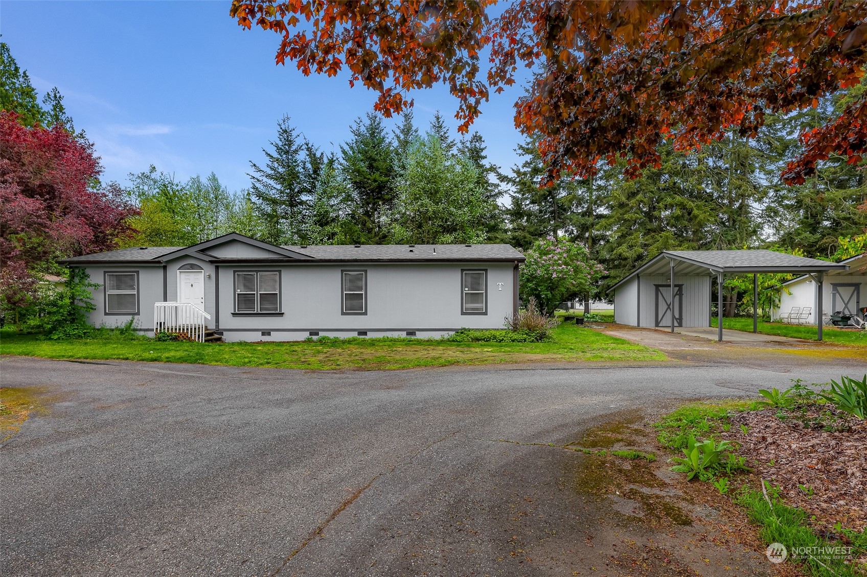 a front view of house with yard and trees