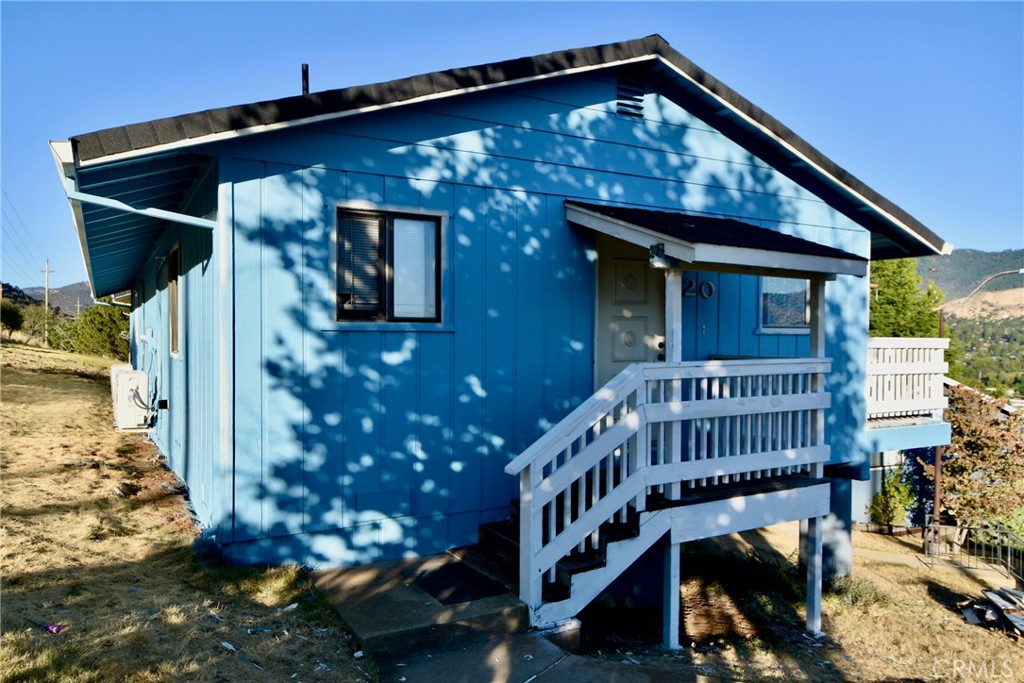 a view of a house with wooden deck