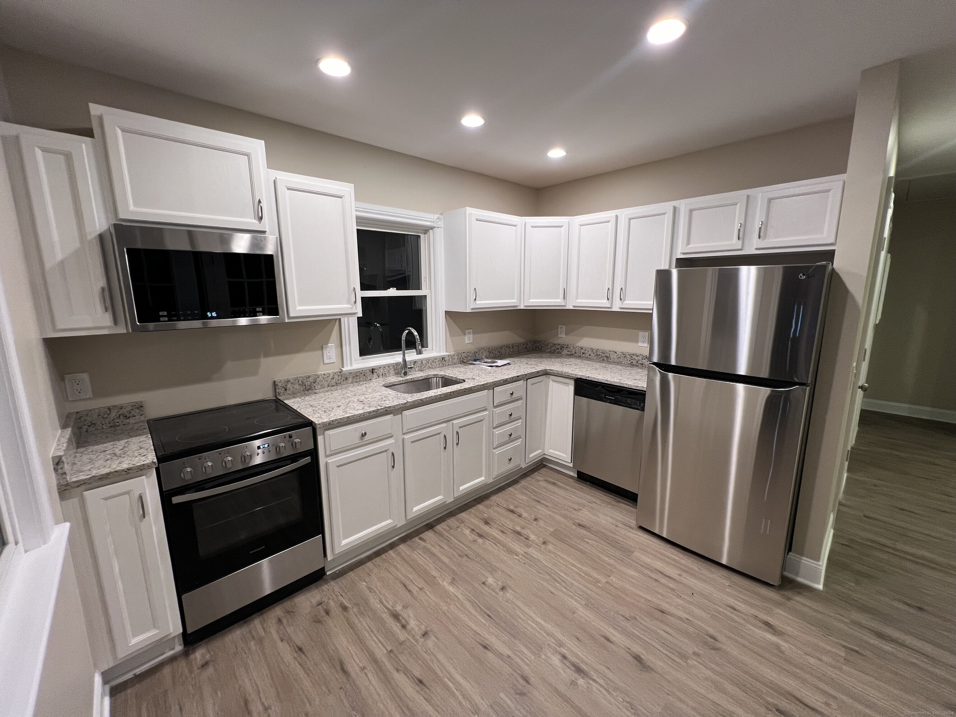 a kitchen with a refrigerator sink and microwave