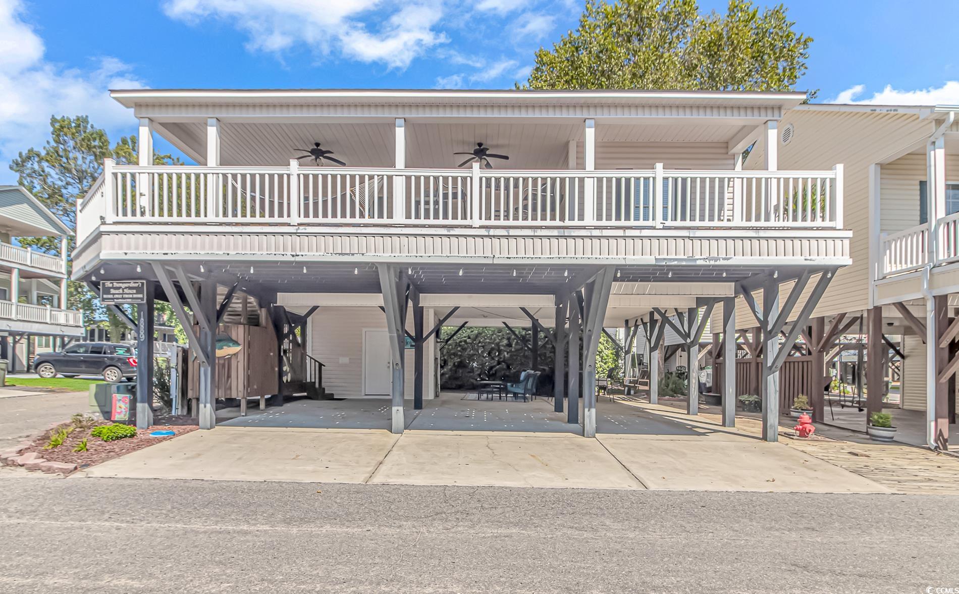 Beach home featuring ceiling fan