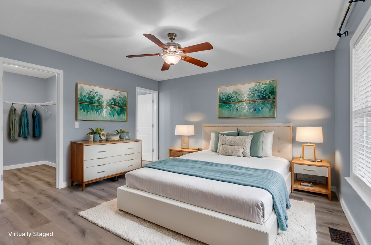 a bedroom with a large bed and a chandelier