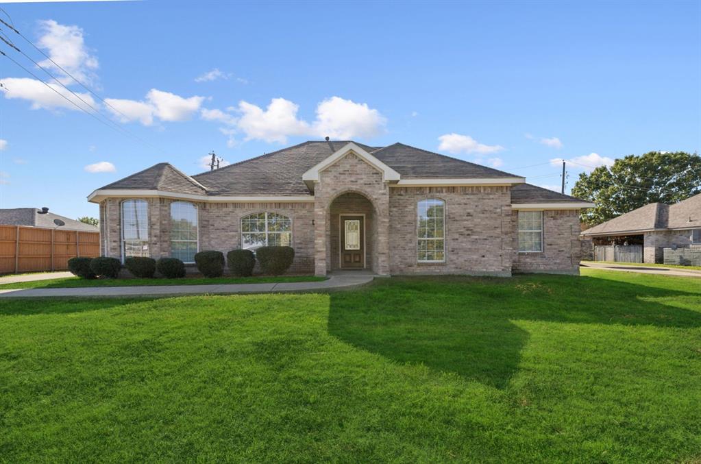 a front view of a house with a garden