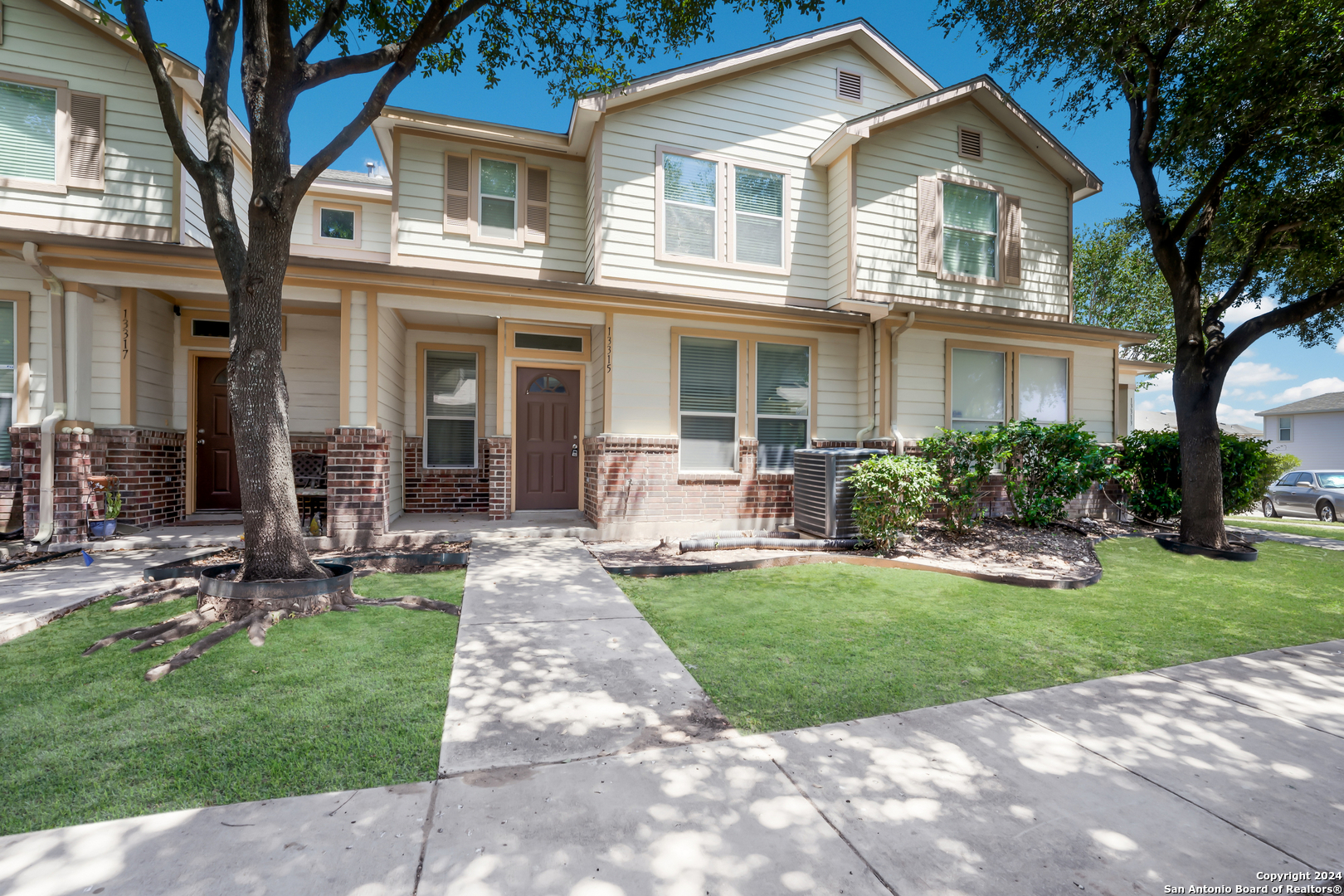 a front view of a house with a yard and patio