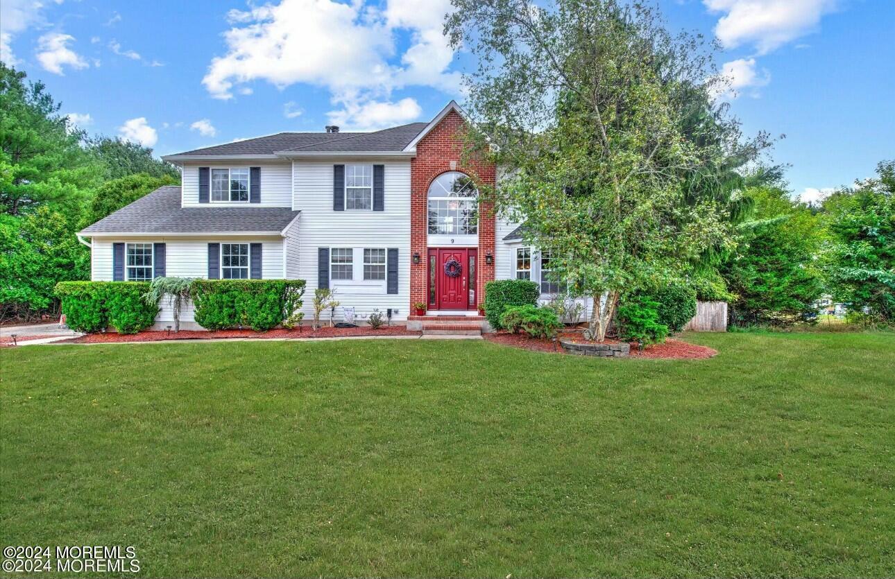 a front view of house with yard and green space