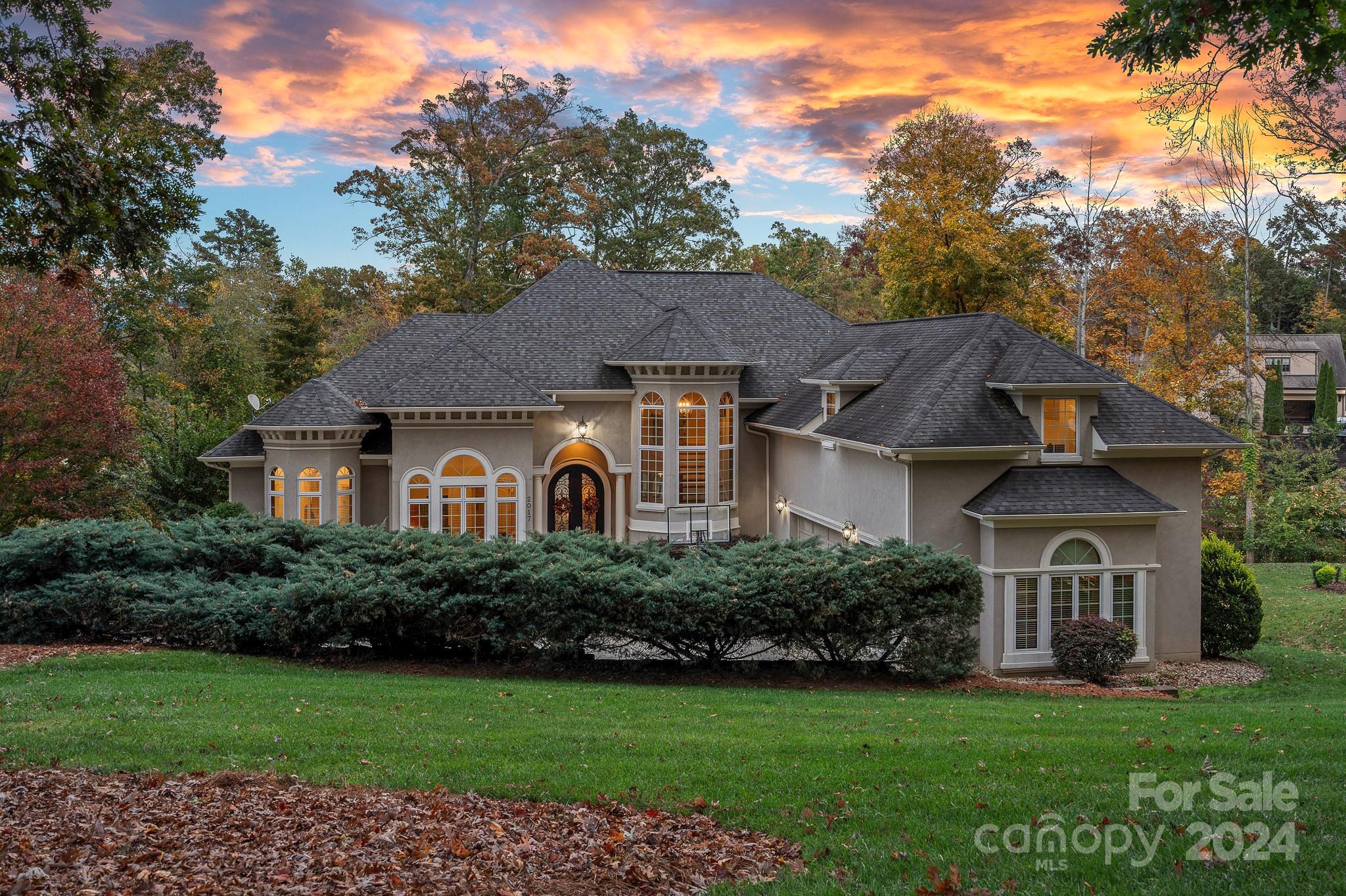 a front view of a house with a garden