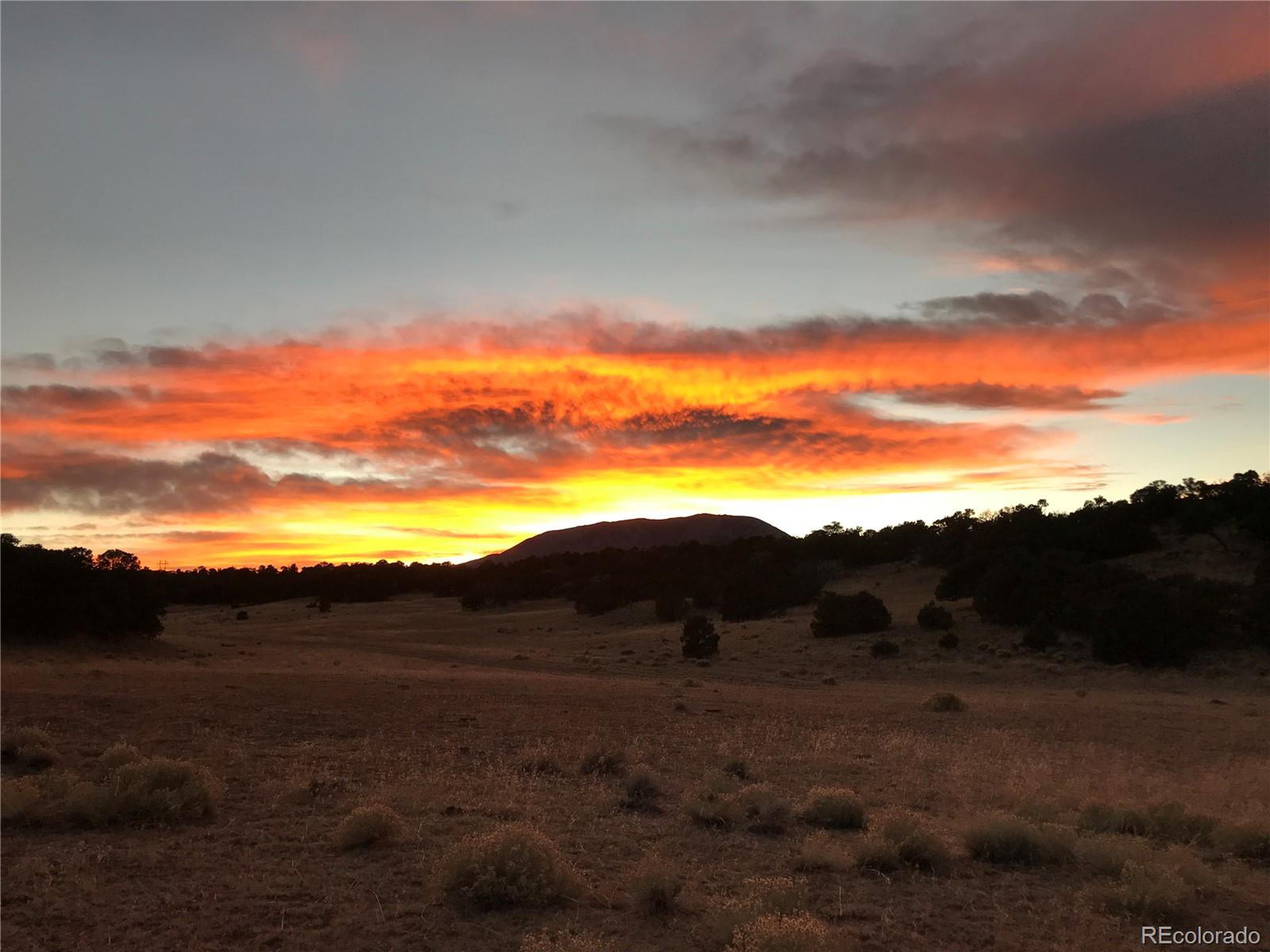 a view of mountain with sunset