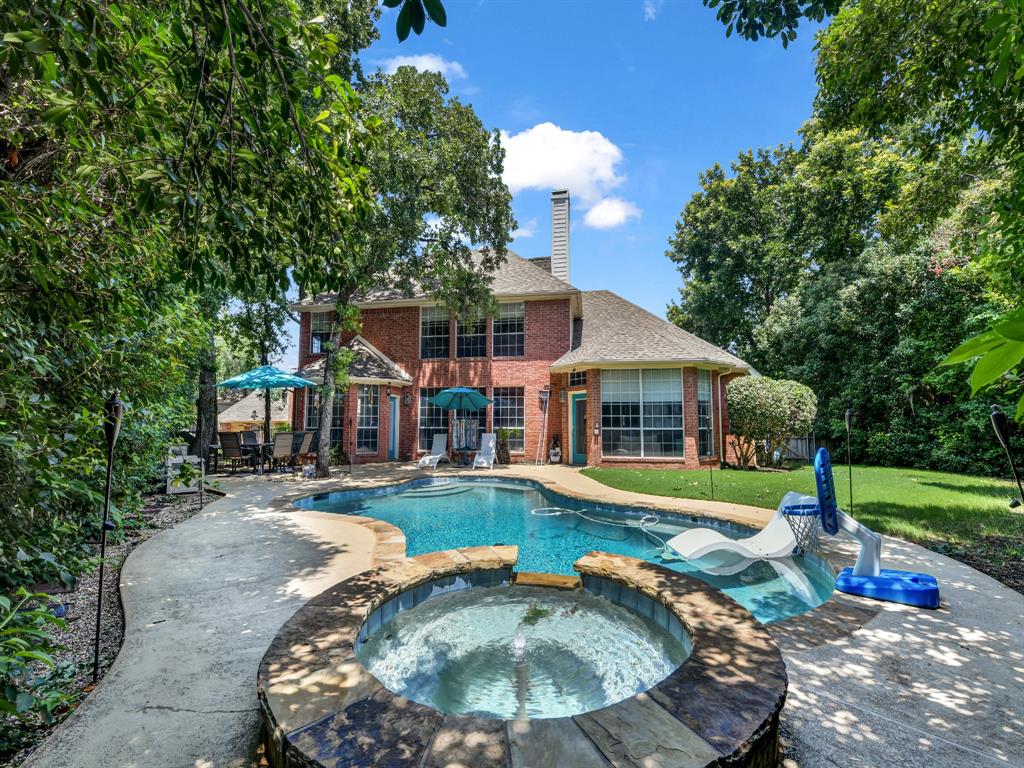 an aerial view of a house with a yard table and chairs