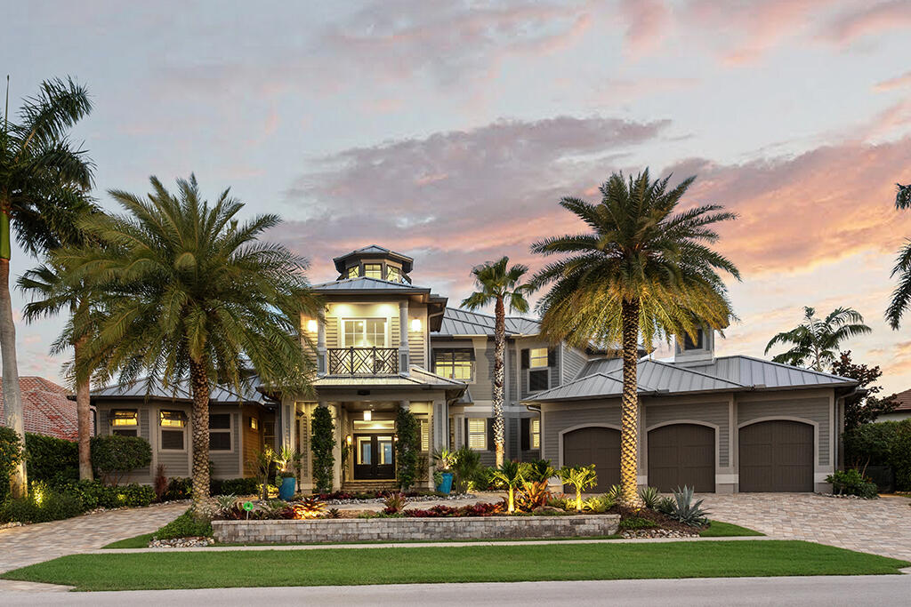 a front view of multiple houses with yard