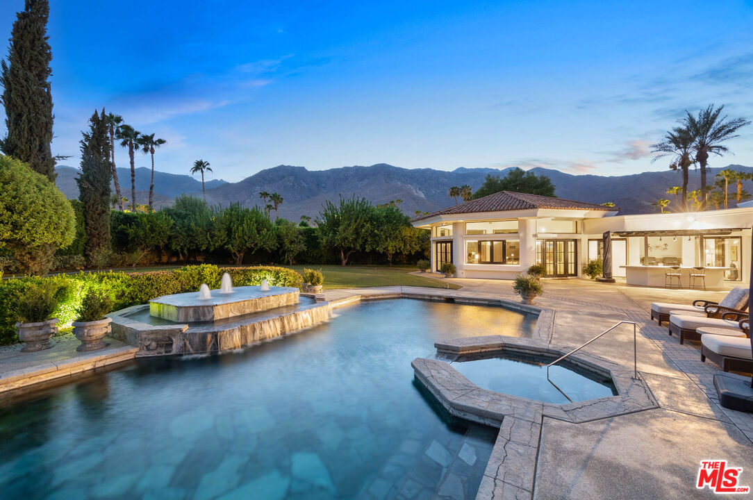 a swimming pool with outdoor seating and yard