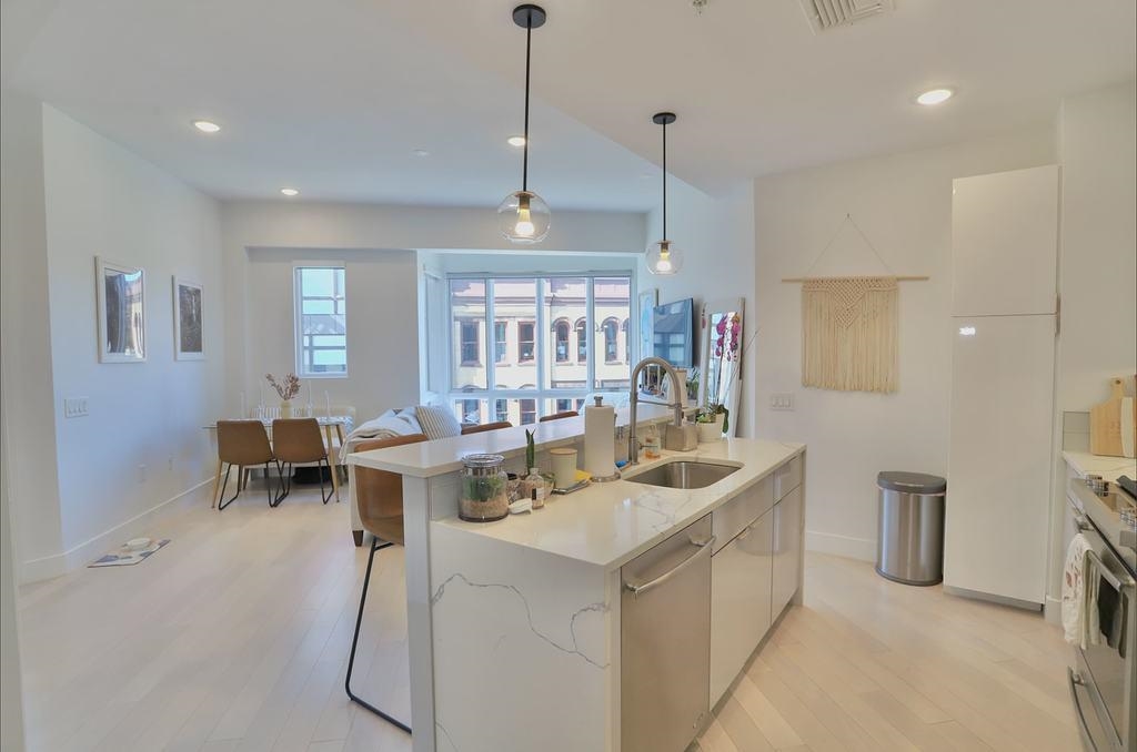 a view of a kitchen with kitchen island granite countertop lots of counter top space