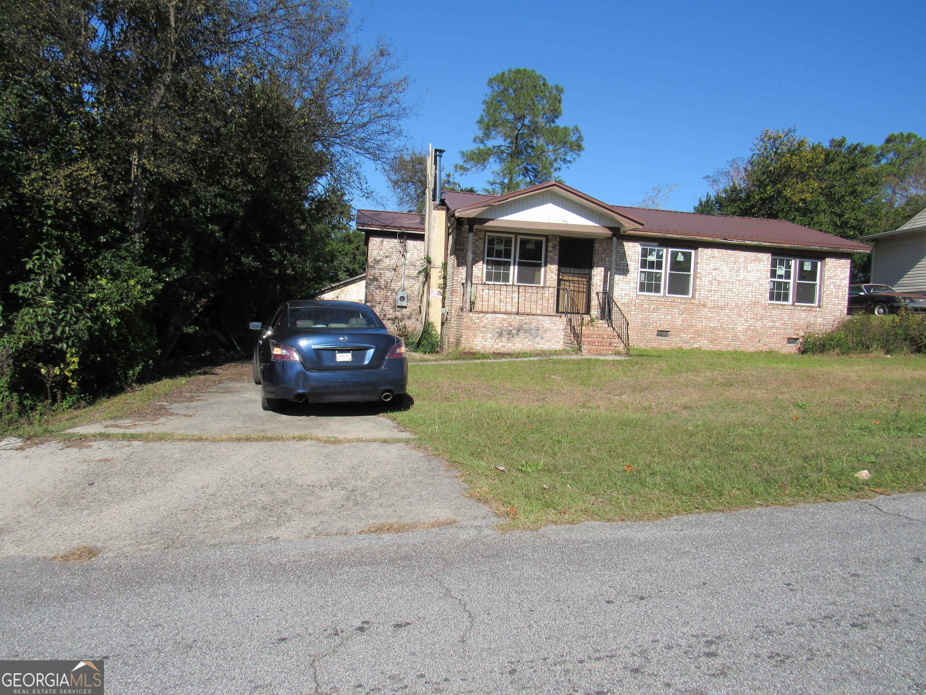 a front view of a house with a garden