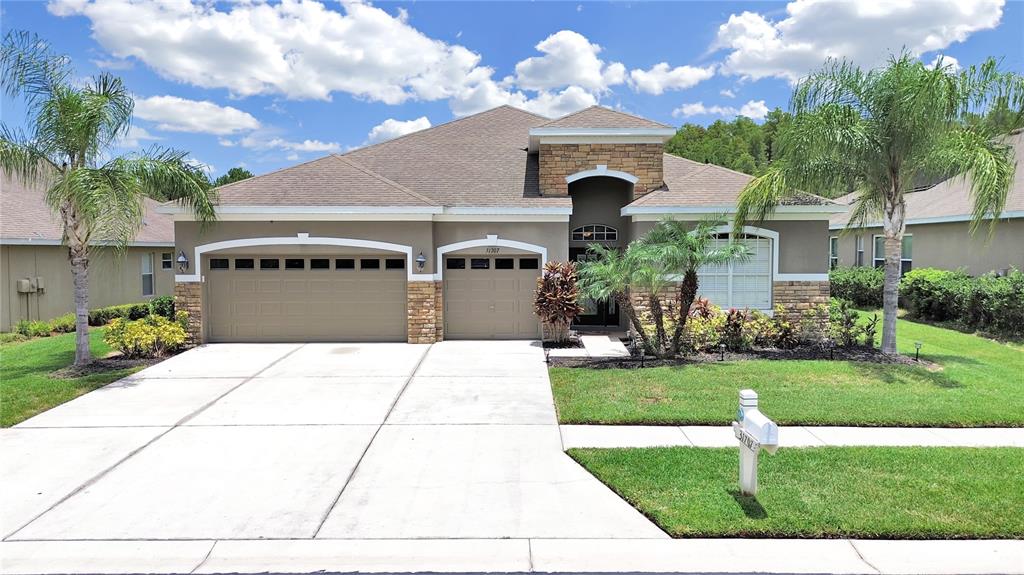 a front view of a house with a garden and a garage