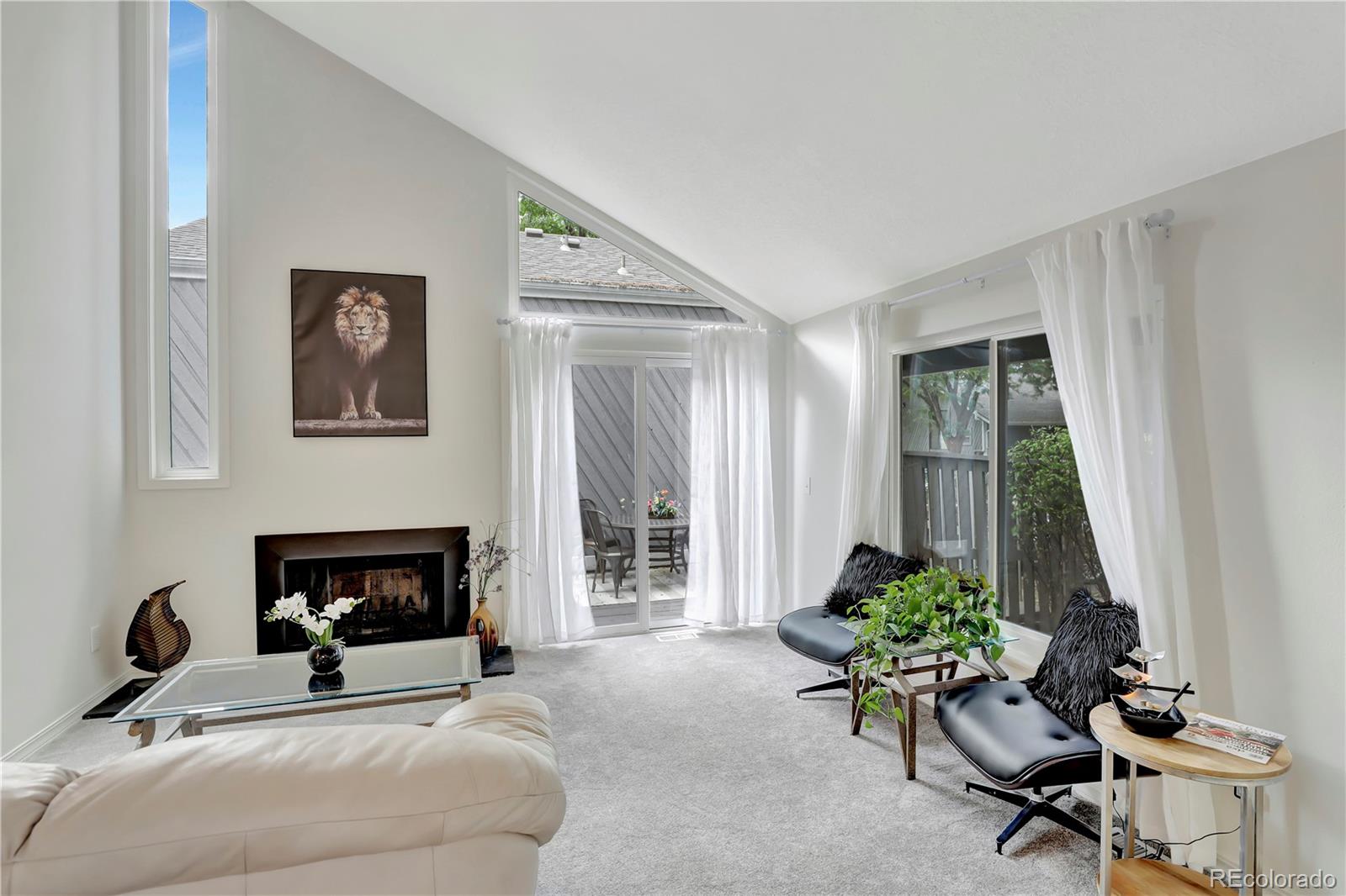 a living room with furniture potted plant and a fireplace