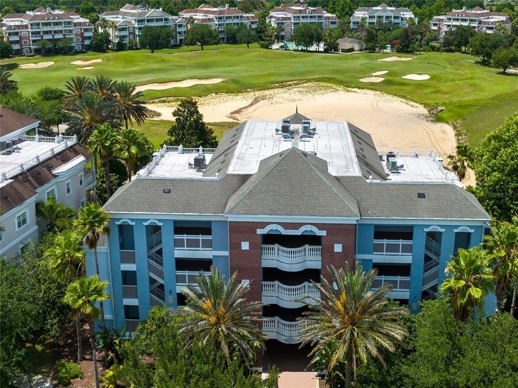 an aerial view of a house with a garden and swimming pool