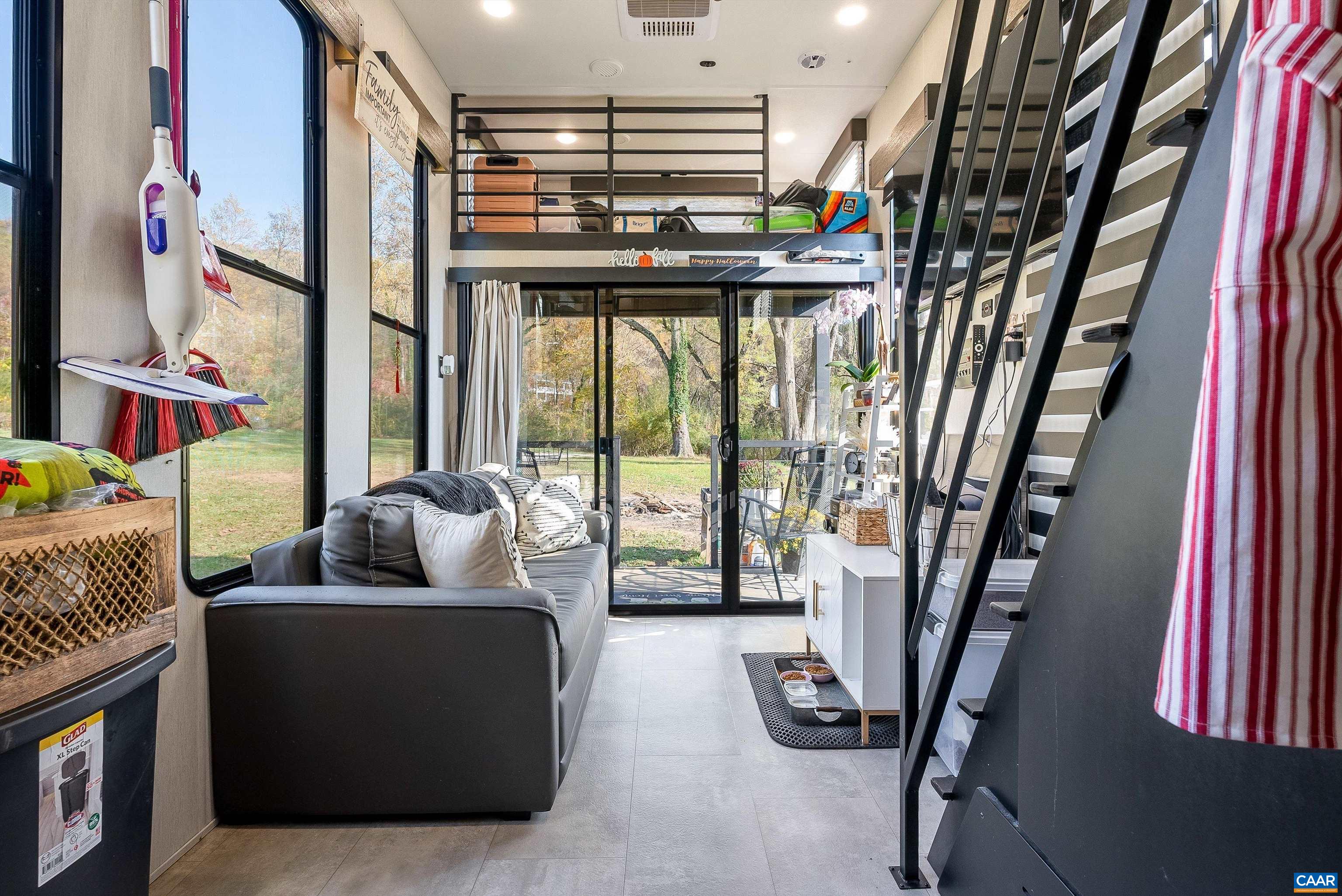 a living room with furniture and a floor to ceiling window