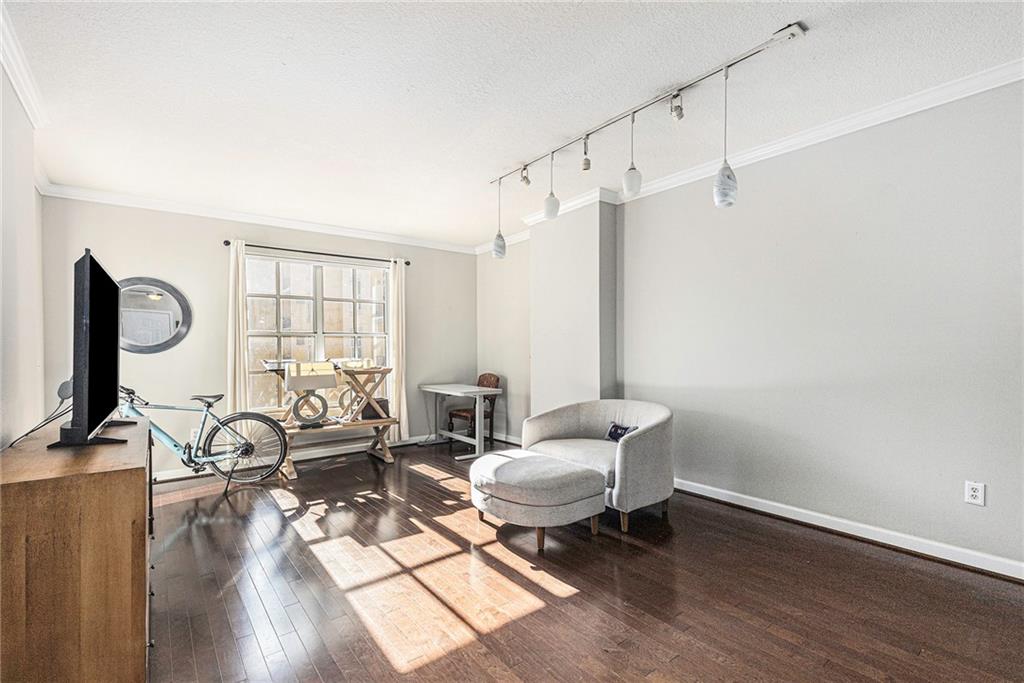 a living room with furniture a flat screen tv and a window