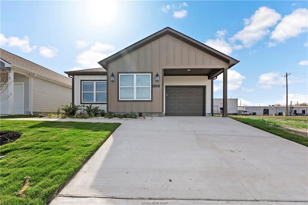 a front view of a house with a yard and garage