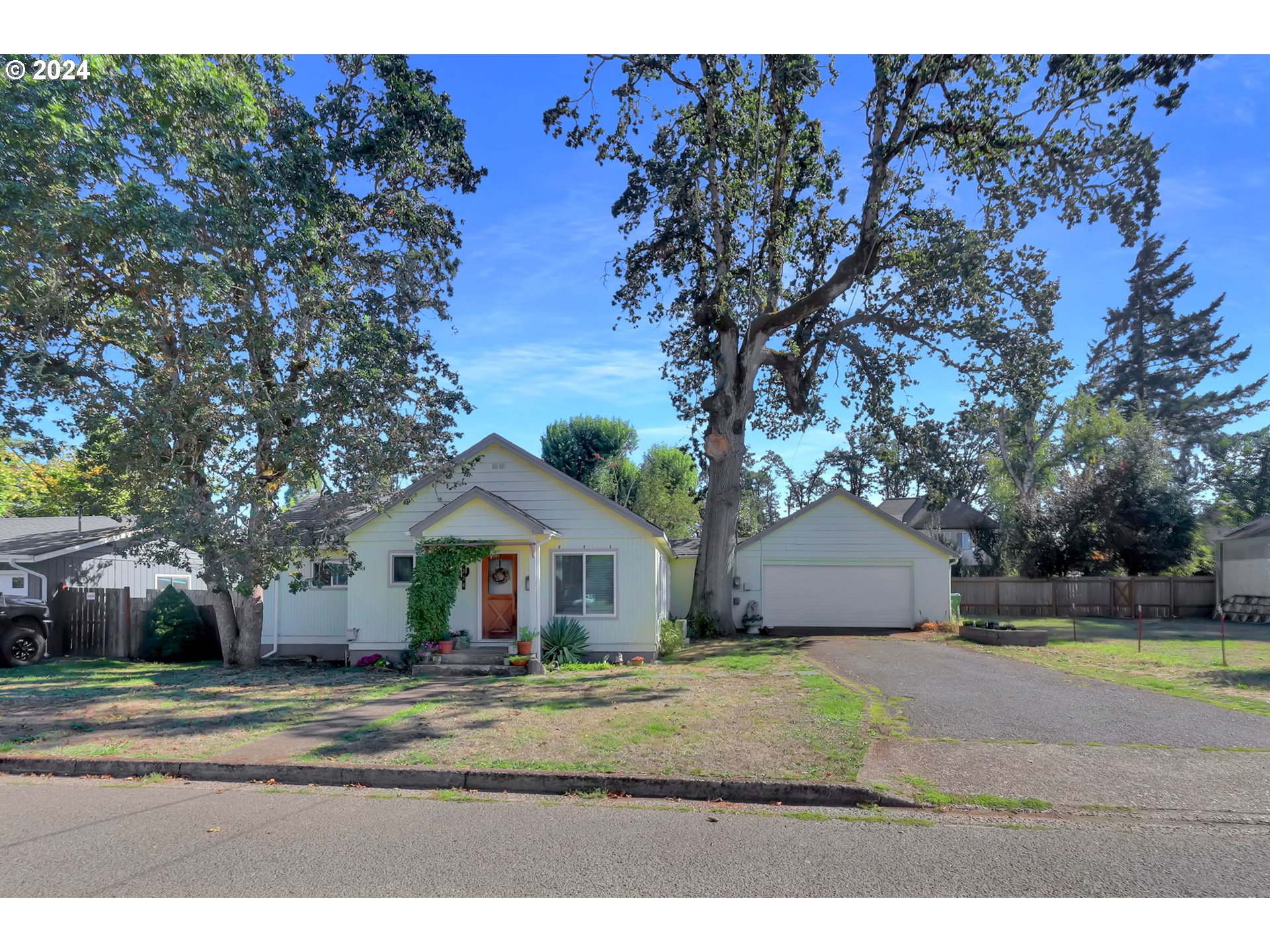 a front view of house with yard and trees