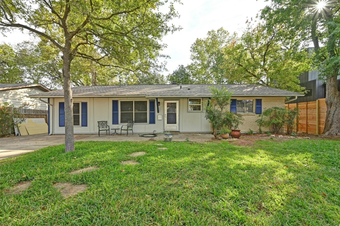 front view of a house with a patio yard and balcony