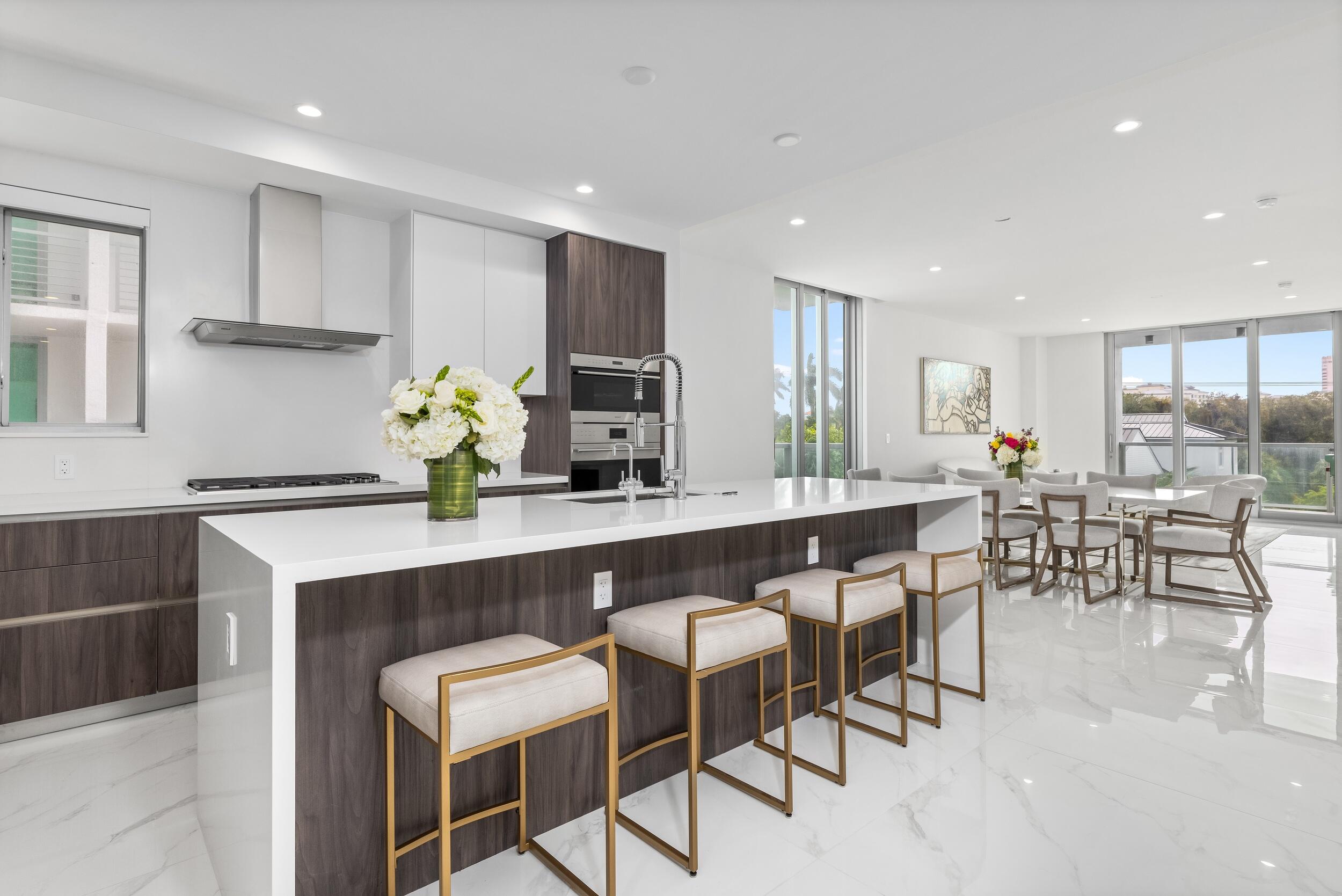 a kitchen with kitchen island granite countertop a table and chairs in it