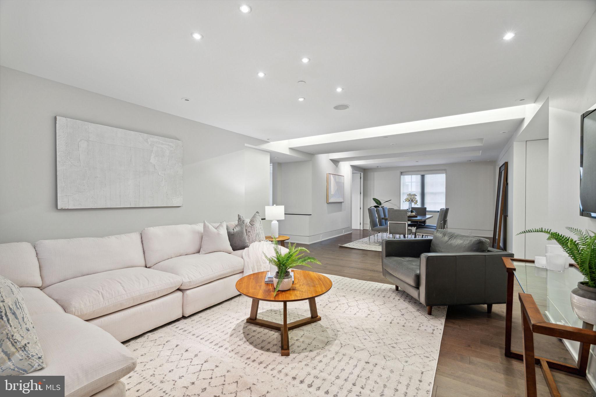 a living room with furniture a rug and a lamp