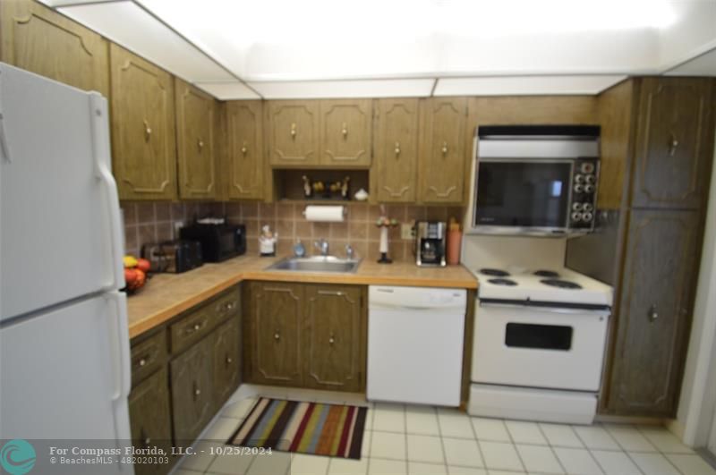 a kitchen with a sink cabinets and appliances