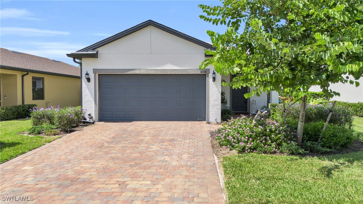 a front view of a house with a yard and garage