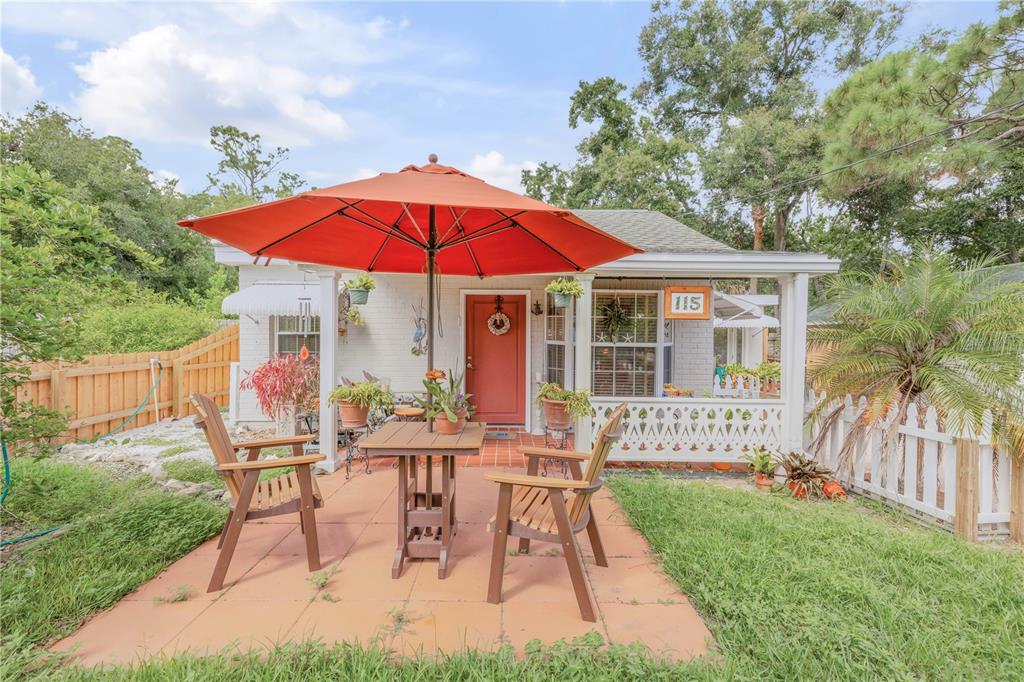 a view of a house with backyard sitting area and garden