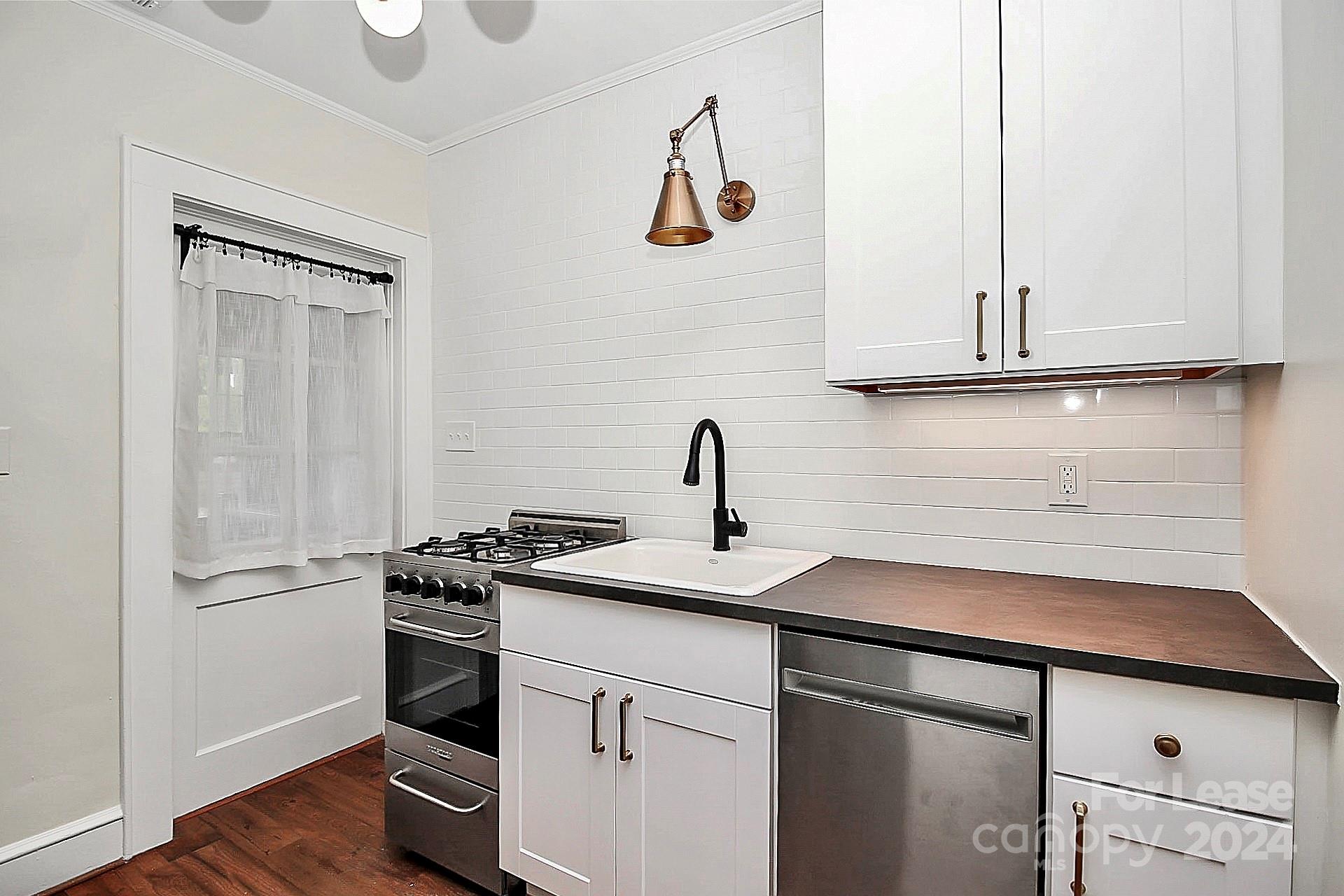 a kitchen with a sink and a refrigerator