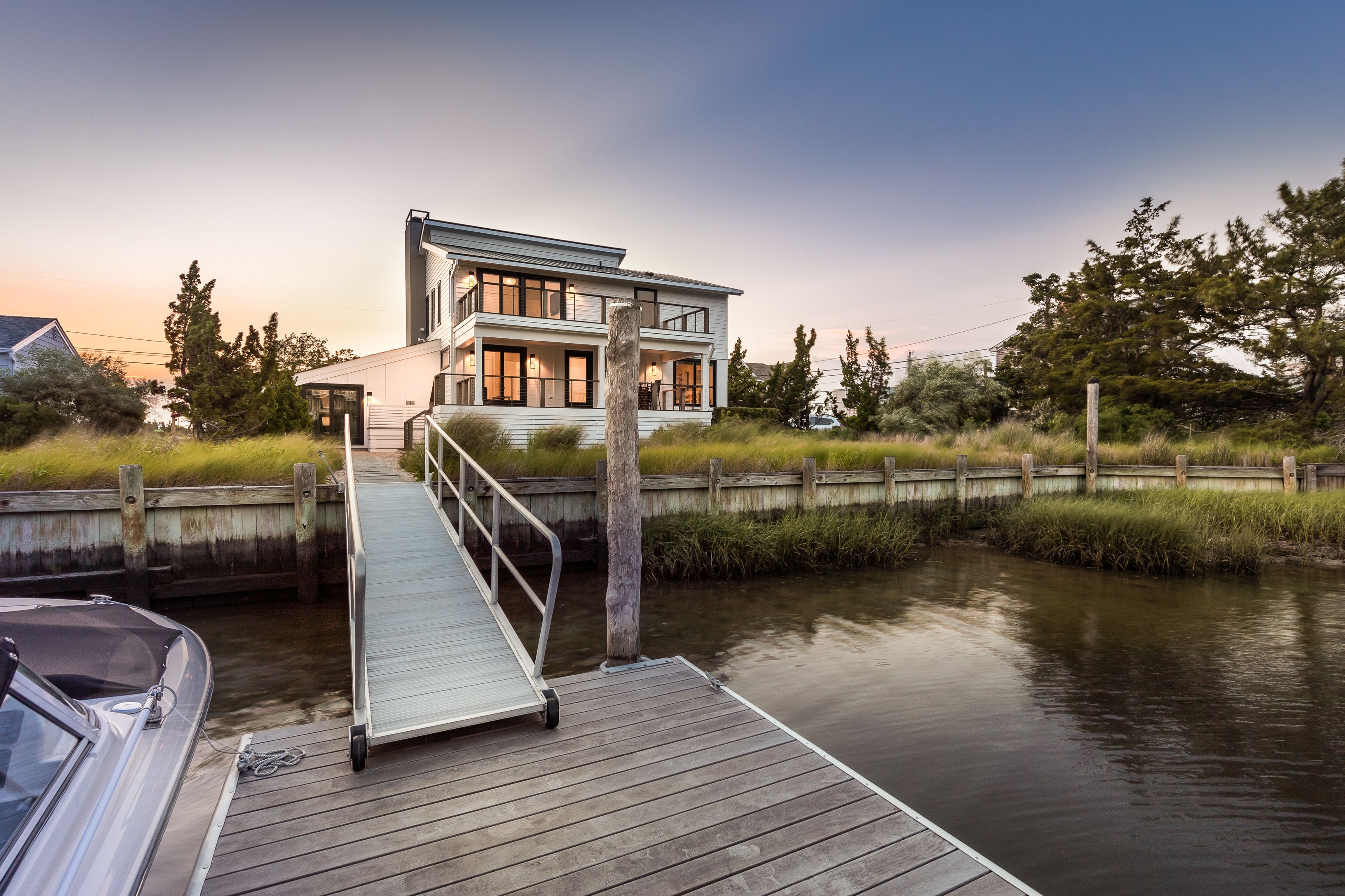 a view of a house with pool and lake view