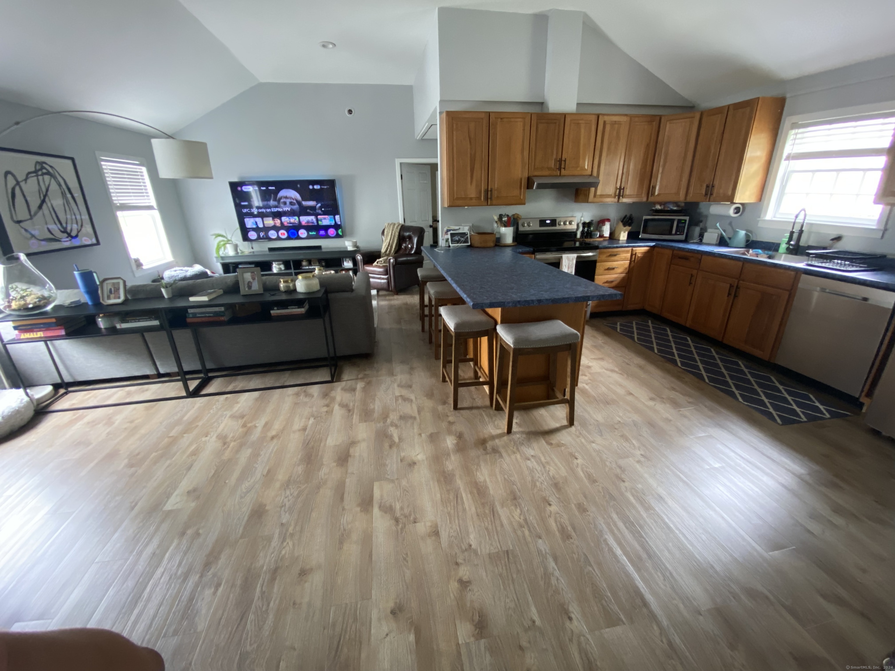 a living room with furniture and a wooden floor