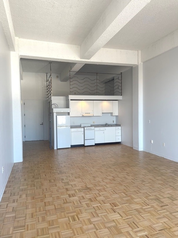 a view of an empty room with a fireplace