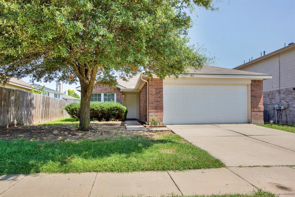 a front view of a house with a yard and a garage