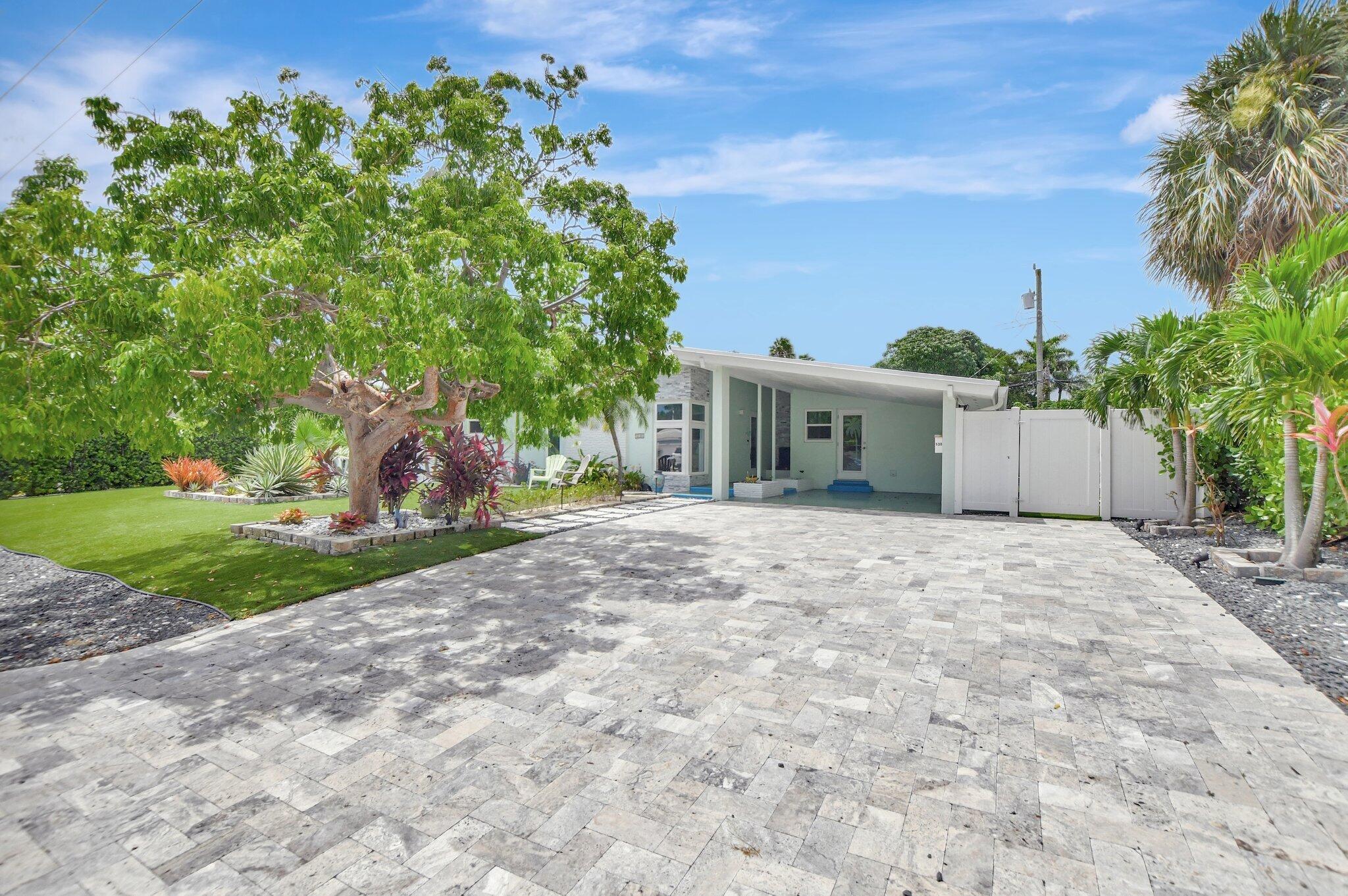 a front view of a house with a yard and a garage