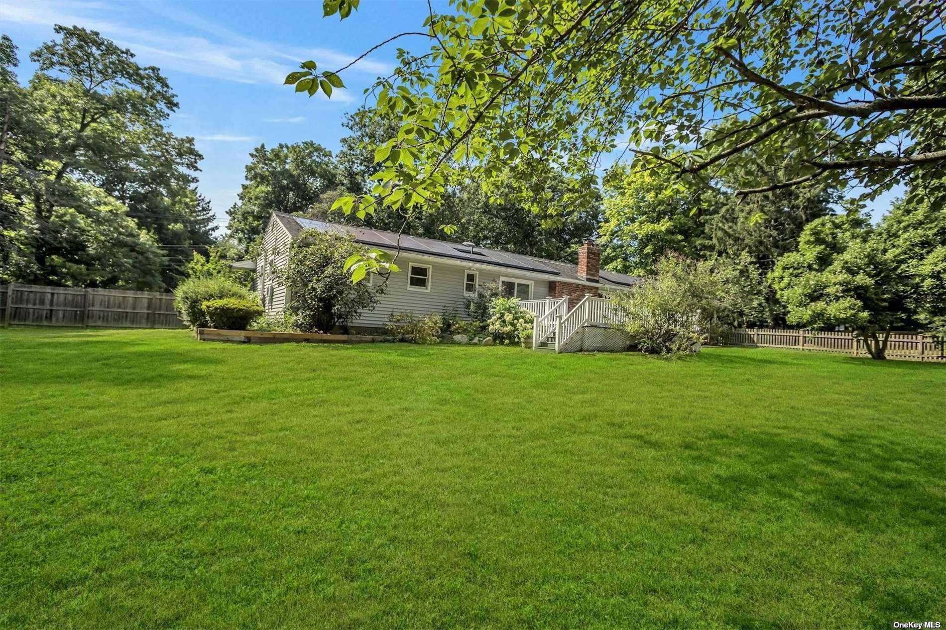 a view of house with backyard