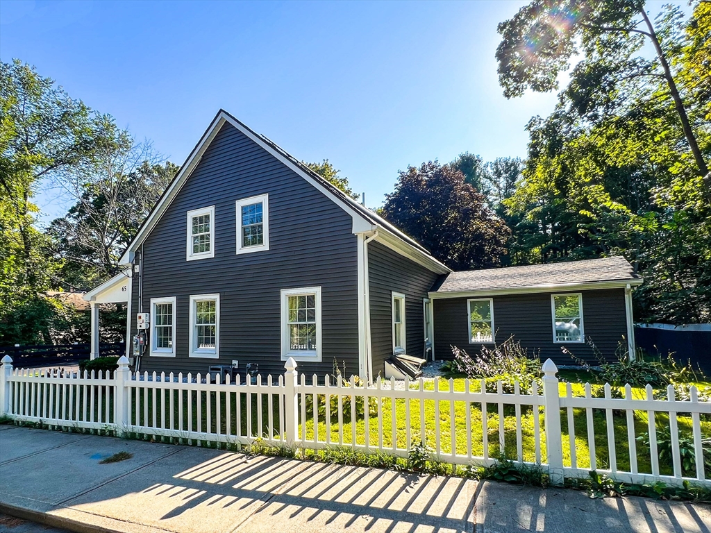 a view of a house with a porch and furniture