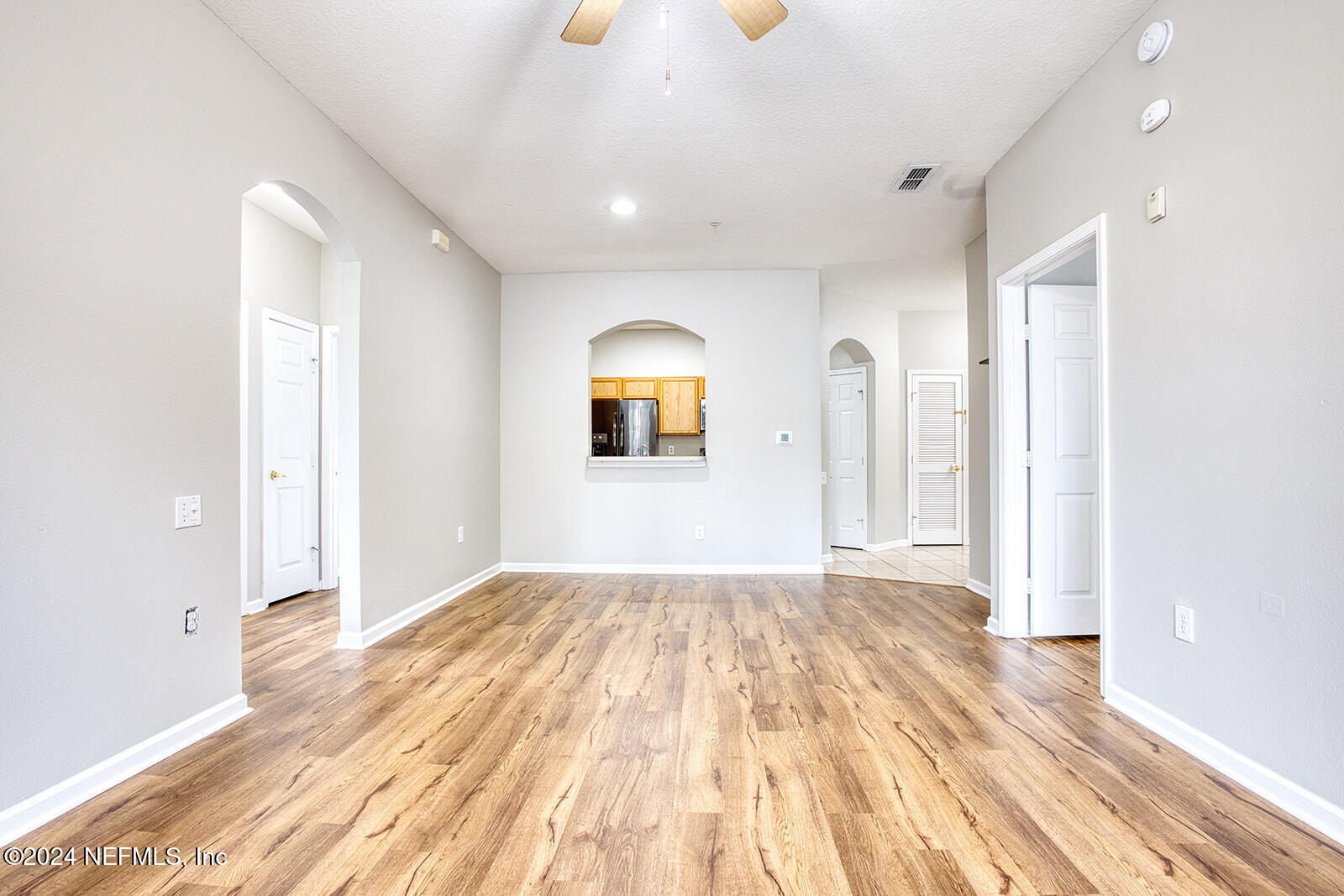 a view of a room with wooden floor and window