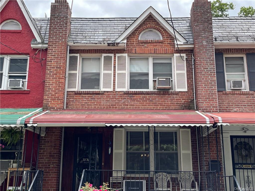 a view of a brick house with large windows