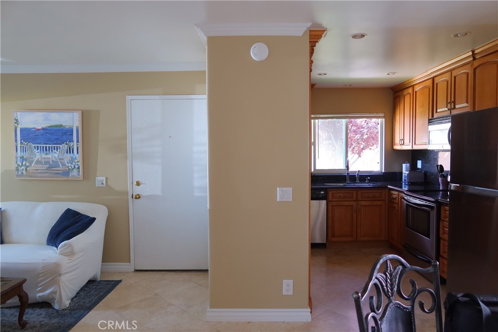 a kitchen with a refrigerator and a stove top oven