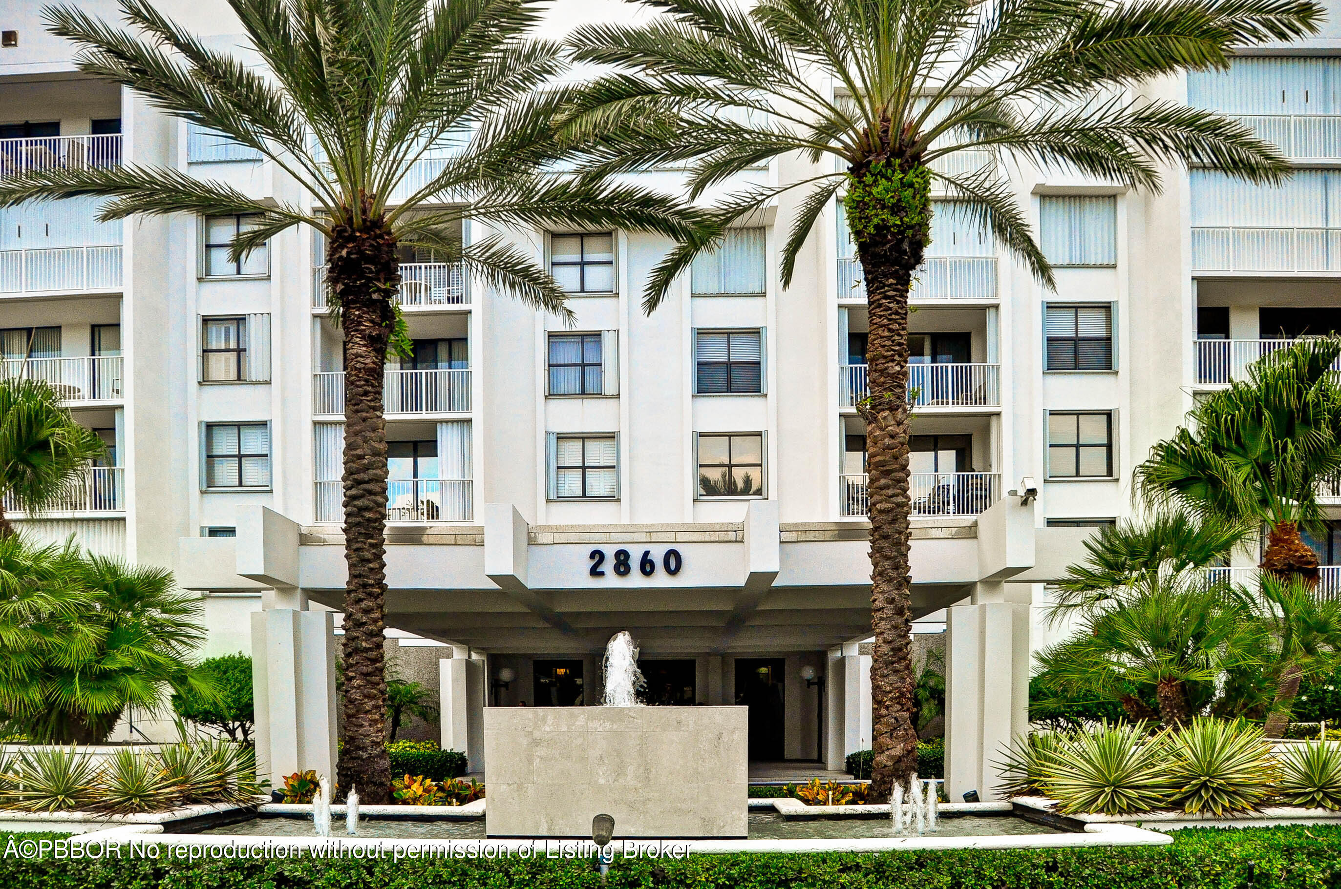 a front view of a building with garden